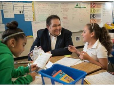 A volunteer teaching students in a classroom